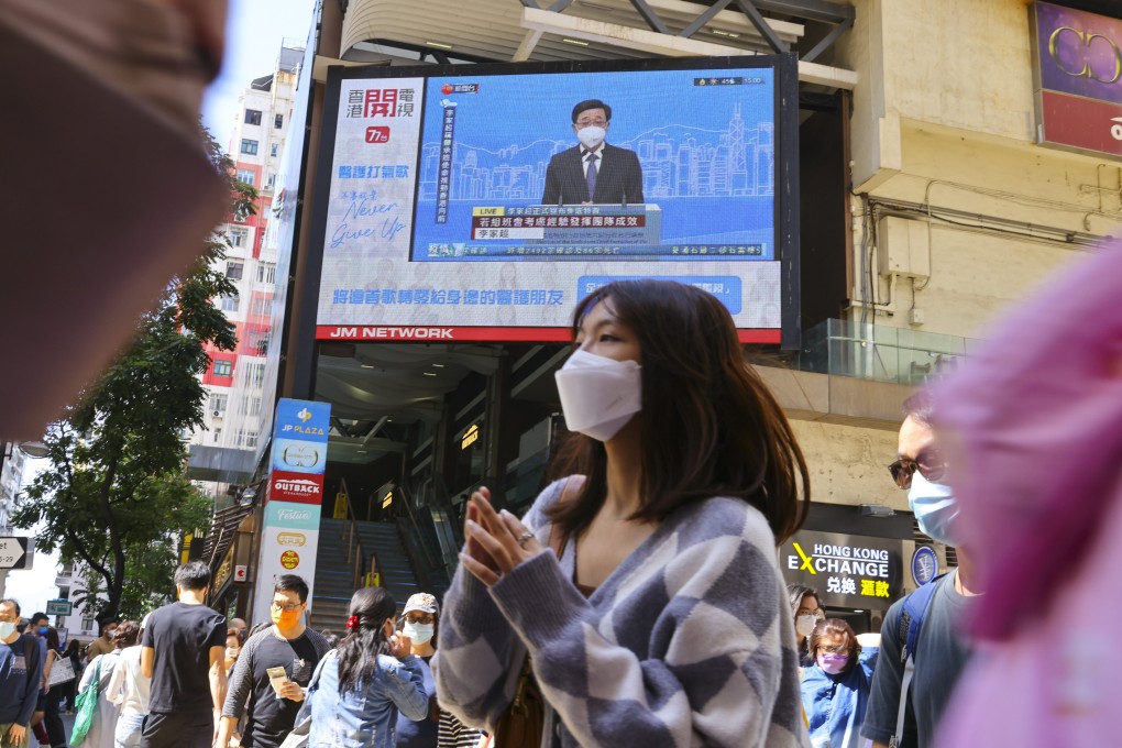 A live broadcast of an online press conference by chief executive hopeful John Lee is shown in Causeway Bay on April 9. Photo: Dickson Lee