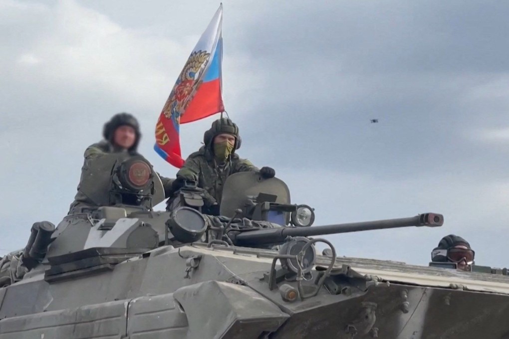 Russian servicemen sit on a tank advancing along a road in the Kharkiv region of Ukraine. Photo: Russian defence ministry via AFP