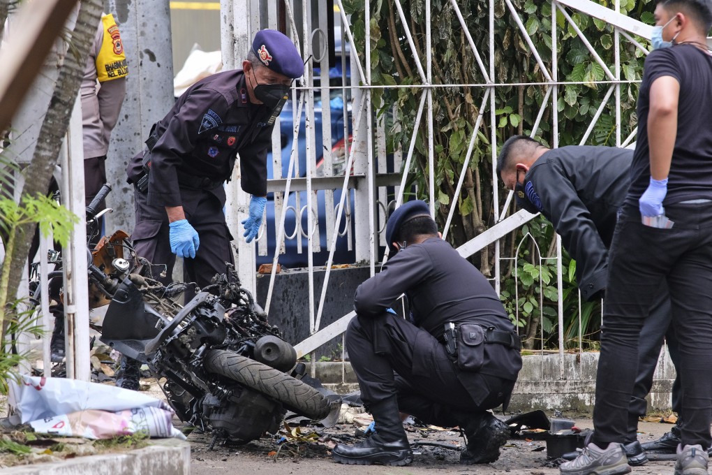 Members of a police bomb squad inspect the wreckage of a motorbike used to carry out Sunday’s suicide bomb attack at the Sacred Heart of Jesus Cathedral in Makassar, South Sulawesi, Indonesia in March. Photo: AP