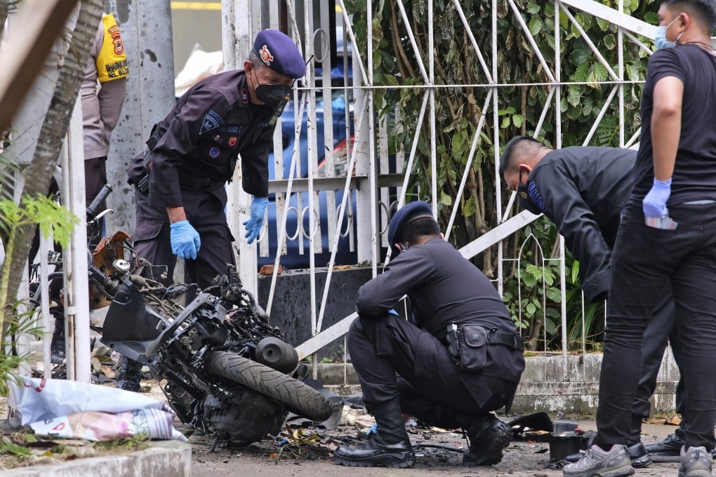 Members of a police bomb squad inspect the wreckage of a motorbike used to carry out Sunday’s suicide bomb attack at the Sacred Heart of Jesus Cathedral in Makassar, South Sulawesi, Indonesia in March. Photo: AP