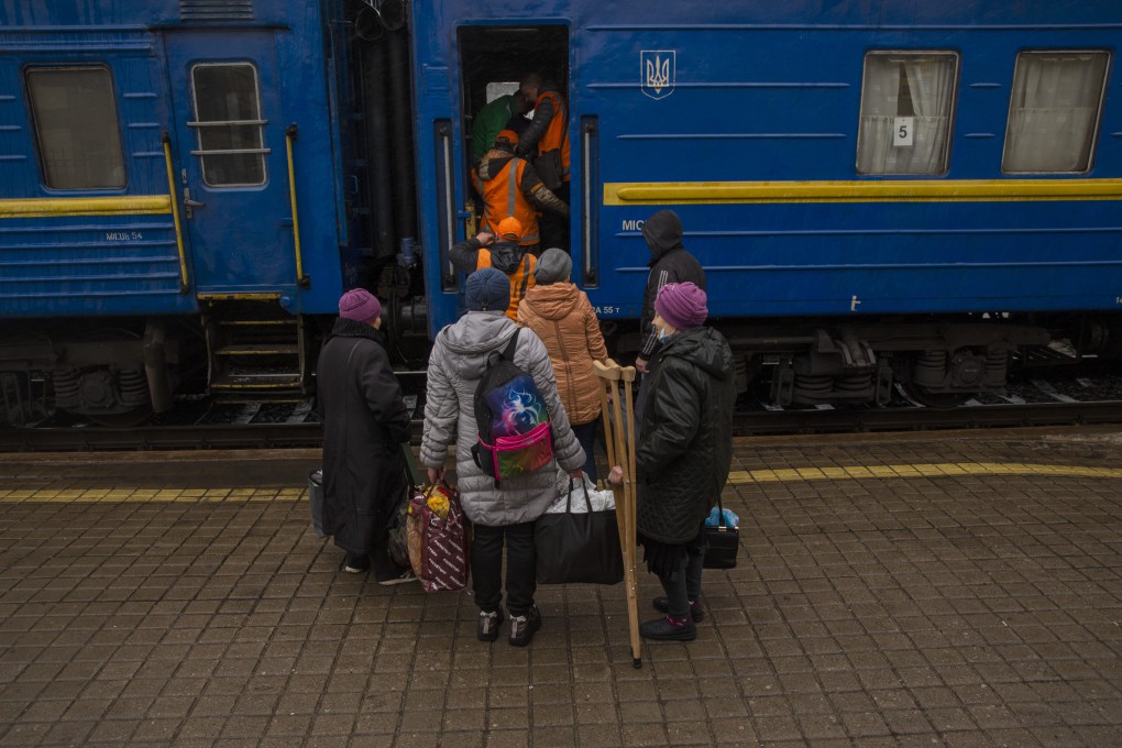 Railway staff in Ukraine help elderly people board a train earlier this month. Several railway stations were attacked by Russia on Monday, with casualties reported. File photo: dpa