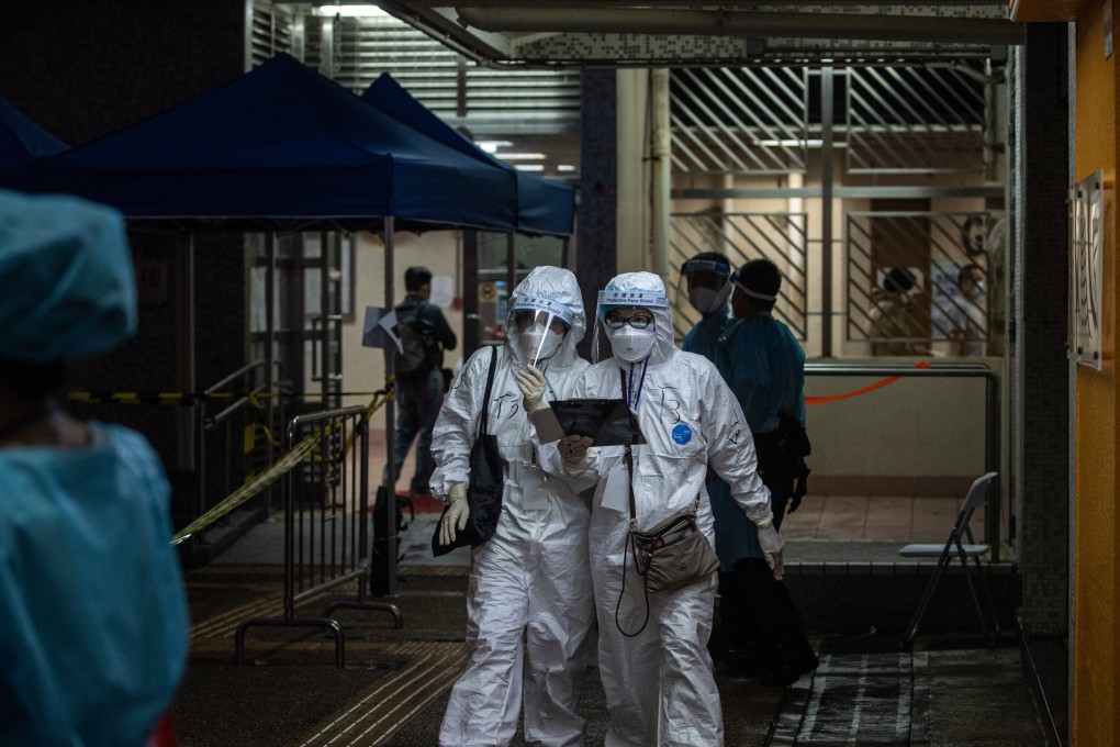Health workers at a building lockdown in Hong Kong. Photo: EPA-EFE