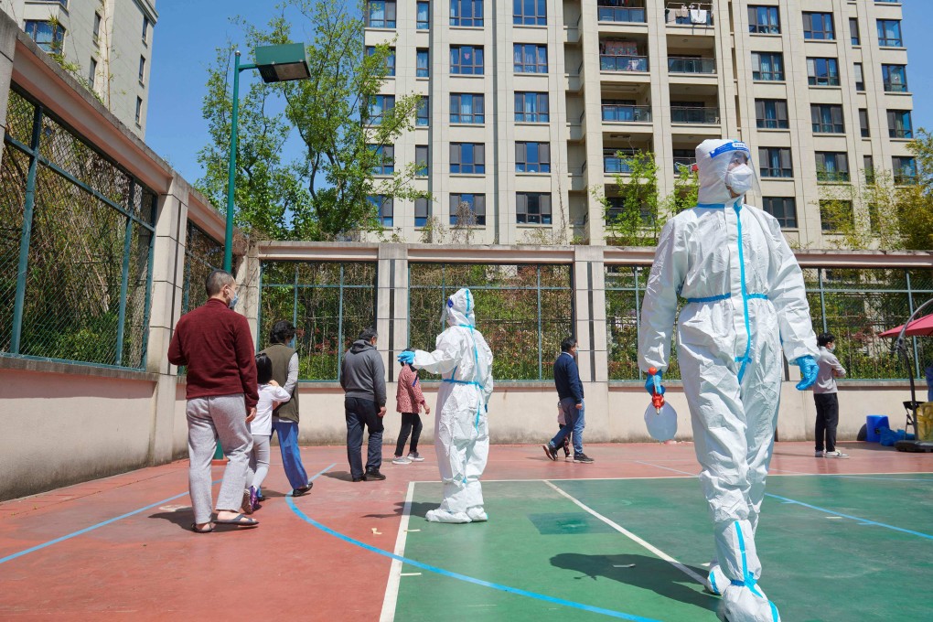 Covid-19 pandemic prevention workers help residents take coronavirus tests in Shanghai. Photo: AFP