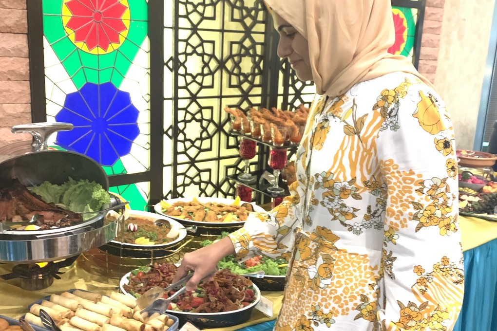 The writer’s neighbour in Kuala Lumpur, Malaysia, Sajida Aziz Omar, breaks her daily Ramadan fast at an Iftar buffet. Omar says dry fasting - consuming no food or water for 13-plus hours - gives her more energy. Photo: Lise Floris