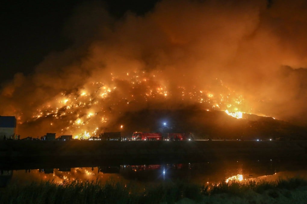 Firefighters battle to control flames at a New Delhi landfill site. Photo: AFP