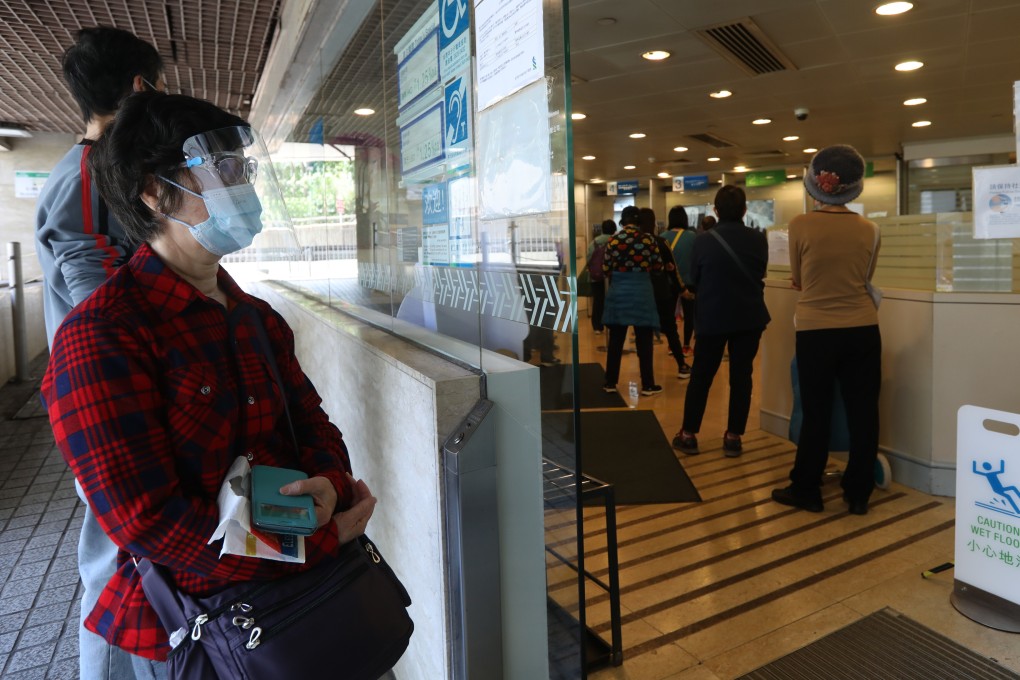 Customers queue at a Standard Chartered branch in Chai Wan amid the fifth wave of coronavirus. Photo: YikYeung-man