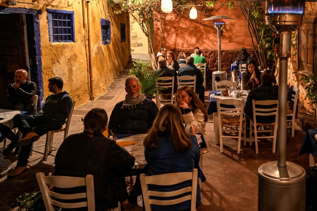Tourists at a restaurant in the old town of Chania on Crete, where the tourist season has started but many operators face an acute shortage of staff. Photo: AFP