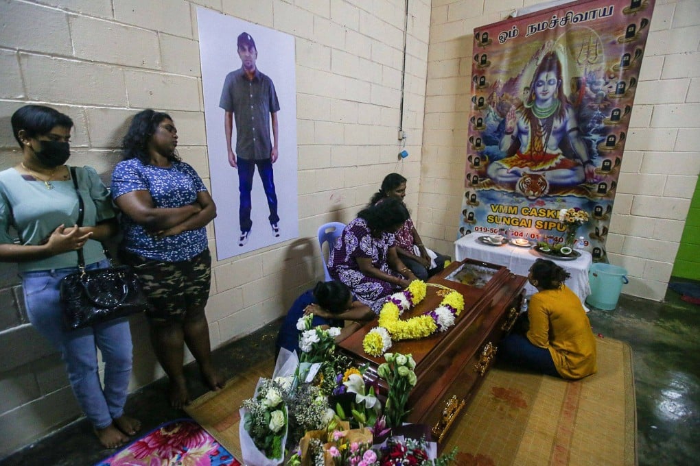 Family members gather by Malaysian national Nagaenthran K. Dharmalingam’s coffin in Malaysia’s Tanjung Rambutan on Thursday, after he was executed for trafficking heroin into Singapore. Photo: AFP