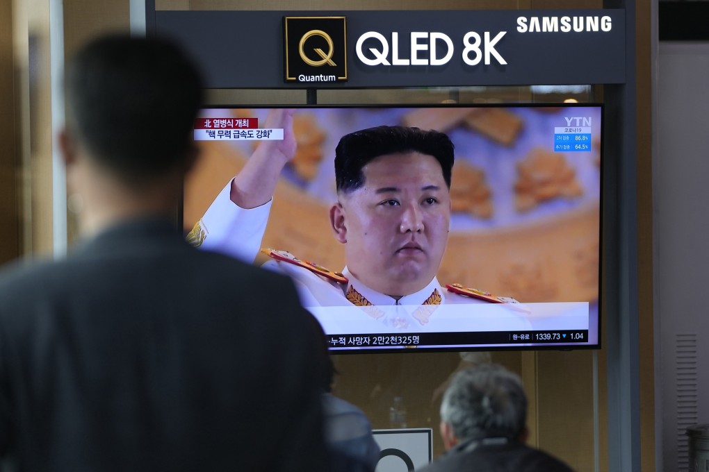 People in Seoul watch a news programme on North Korea’s military parade showing an image of Kim Jong-un. Photo: AP