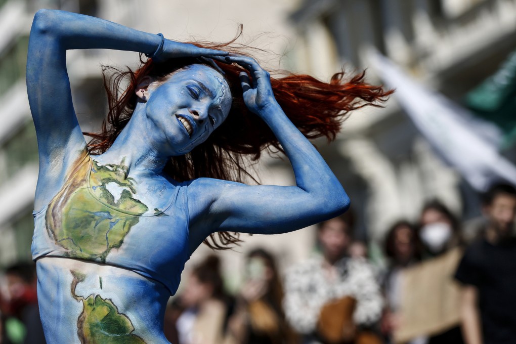 A woman performs a dance during a demonstration for climate justice in Rome, Italy, on Earth Day 2022. Photo: Cecilia Fabiano/LaPresse via AP