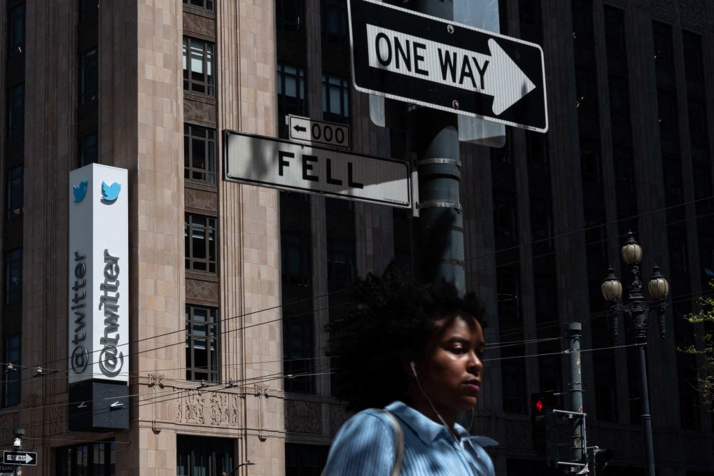 A woman walks past the Twitter headquarters on April 26, in downtown San Francisco, California. Photo: AFP