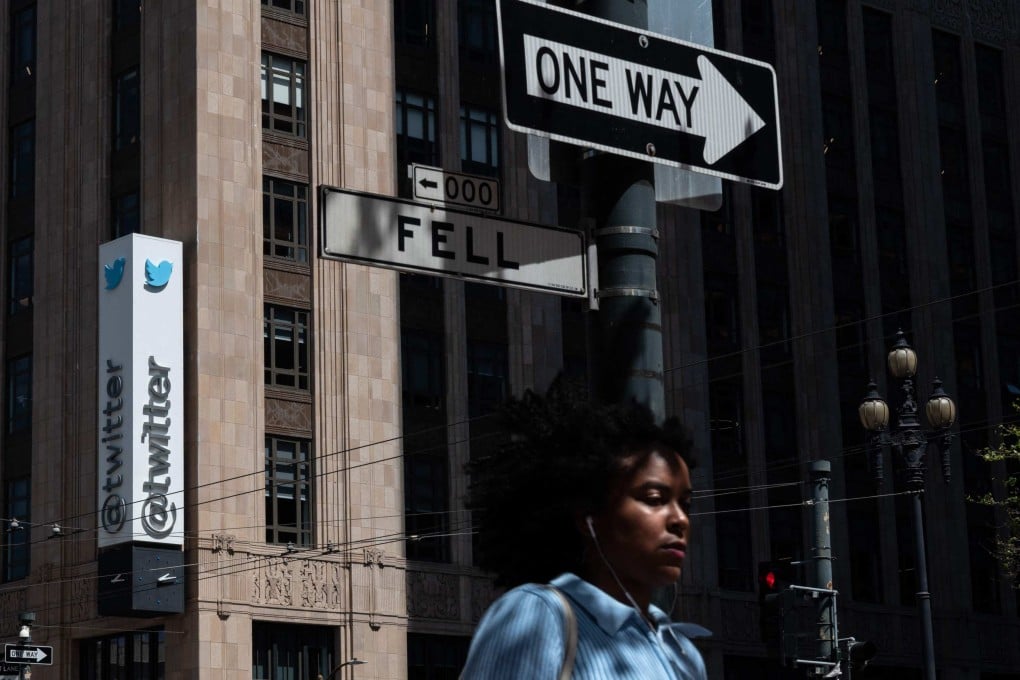 A woman walks past the Twitter headquarters on April 26, in downtown San Francisco, California. Photo: AFP