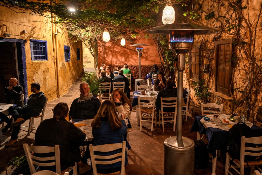 Tourists sit at a restaurant in the old town of Chania on Crete island, Greece, on April 20, as the tourist season kicks off. Europe is seeing a surge in bookings. Photo: AFP
