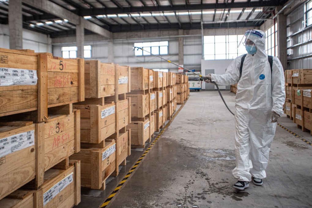 A staff member disinfects the imported goods stored at the warehouse at the Hangzhou Transfar highway port in Hangzhou, in Zhejiang province. Photo: Xinhua