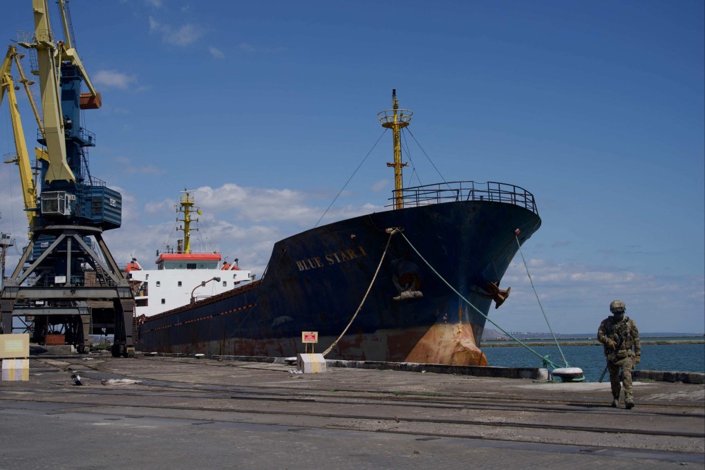 A Russian serviceman patrols the Mariupol port in Ukraine on Friday. Photo: AFP