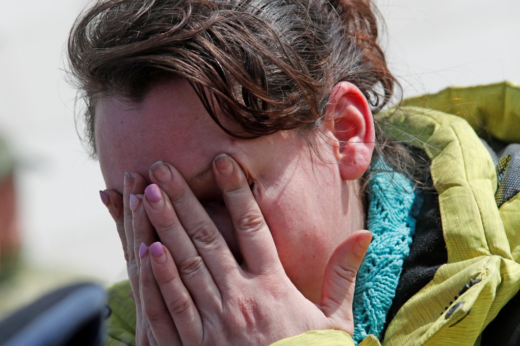 Azovstal steel plant employee Natalia Usmanova, 37, evacuated from Mariupol, reacts upon her arrival on Sunday at a temporary accommodation centre. Photo: Reuters