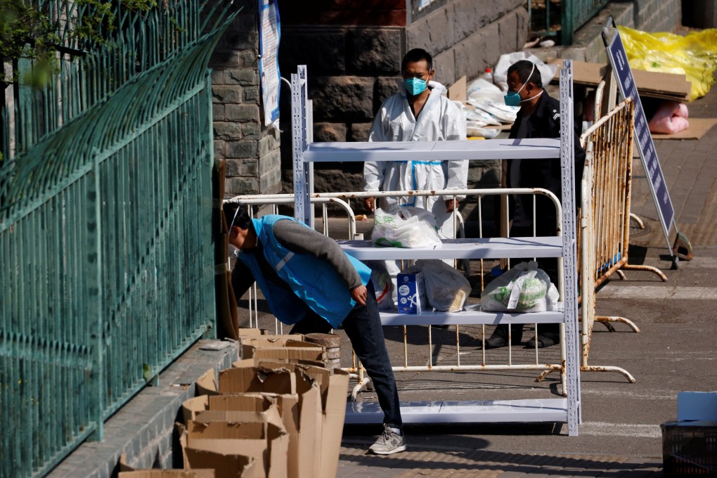 A courier makes deliveries outside a residential compound under lockdown in Beijing on Monday. Photo: Reuters