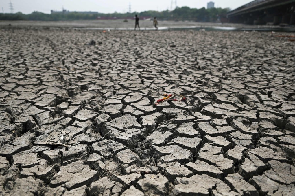 People walk across the parched Yamuna  river bed in New Delhi. Photo: AFP