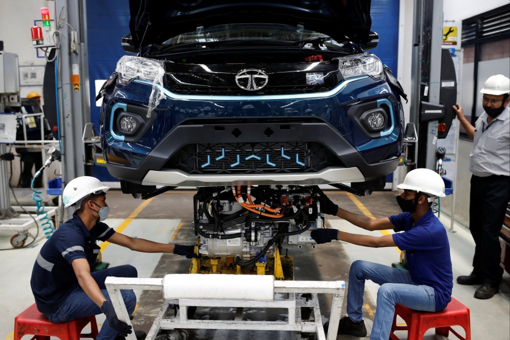 Workers install an electric motor inside a Tata Nexon electric sport-utility vehicle at the Tata Motors plant in Pune. Photo: Reuters