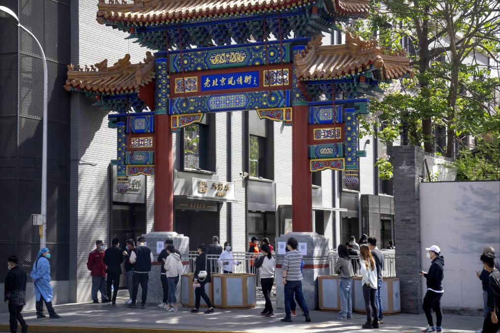 People queue for coronavirus tests in Beijing’s Dongcheng district on April 26. Authroities announced mass testing of the city’s 21 million residents as fears of a Shanghai-style lockdown sparked  stockpiling of food. Photo: AP