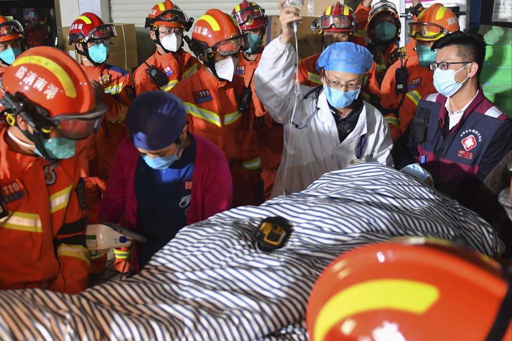 Rescuers attend to a ninth person pulled from the rubble 88 hours after a building collapsed in Changsha on Friday. Photo: Xinhua via AP