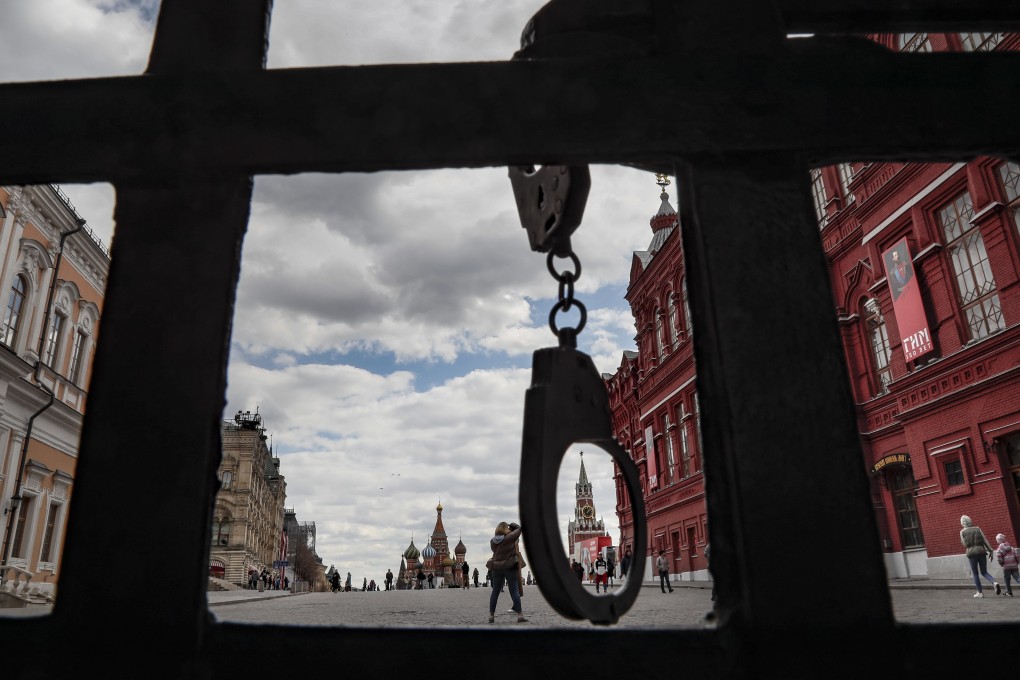 Handcuffs hang from a closed gate to Red Square in Moscow, Russia. Photo: EPA