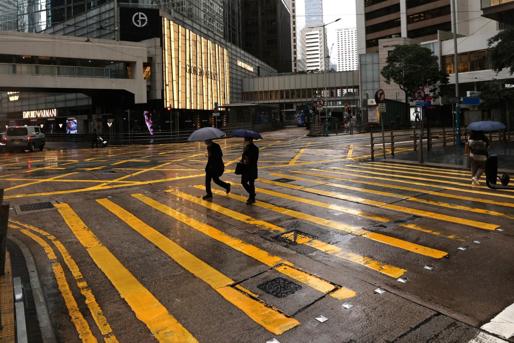 A street in Hong Kong’s Central business district is quiet on a rainy afternoon on February 21. The pandemic and ensuing restrictions have led many to re-examine their career path and identity. Photo: Nora Tam