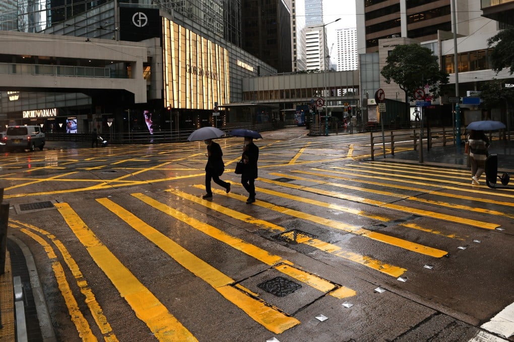 A street in Hong Kong’s Central business district is quiet on a rainy afternoon on February 21. The pandemic and ensuing restrictions have led many to re-examine their career path and identity. Photo: Nora Tam