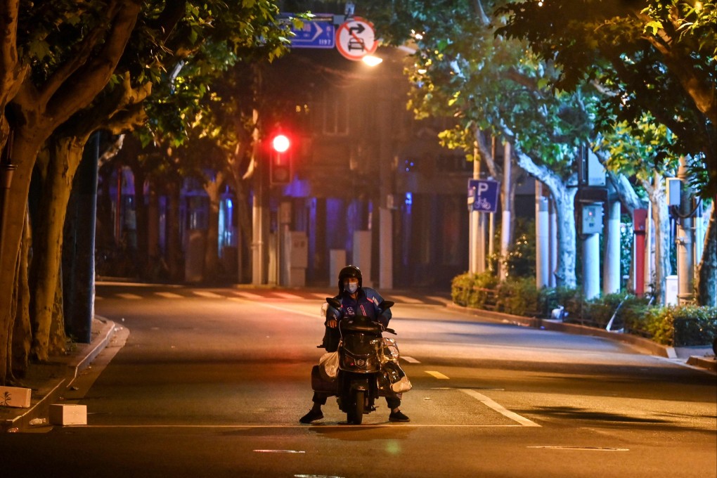 A resident sat on a scooter in a street in the Jing’an district of Shanghai on May 3, 2022. Photo: AFP