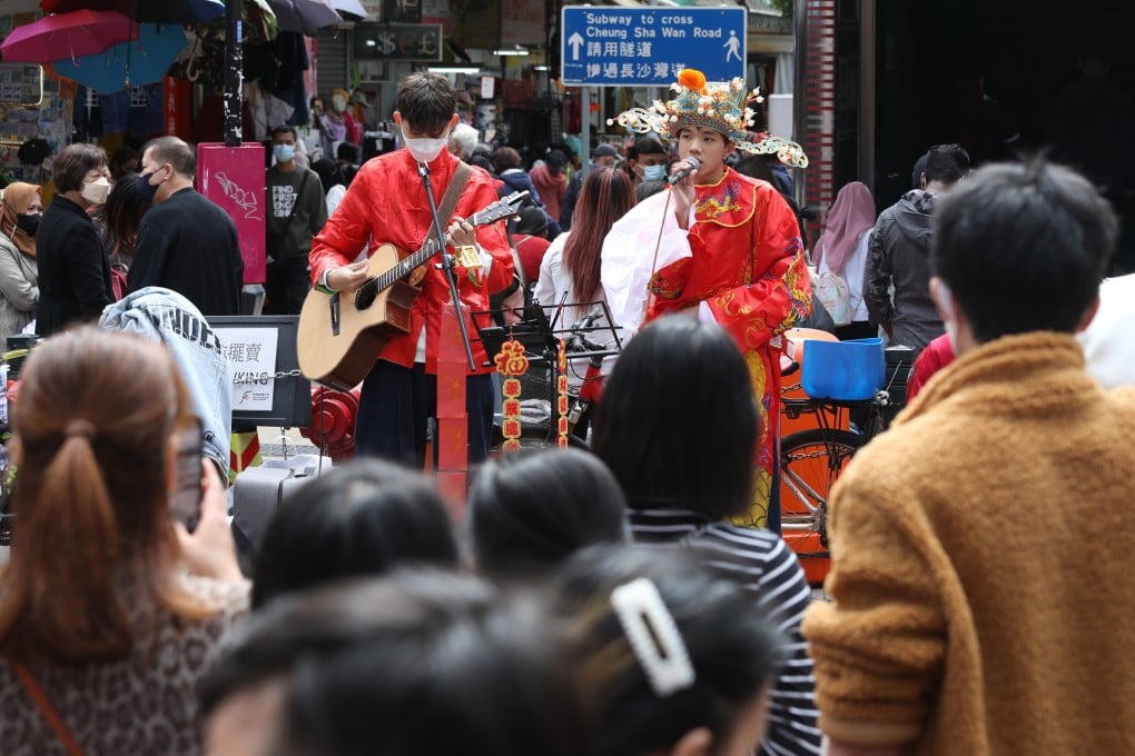 A man dressed as the God of Wealth sings on the street in Sham Shui Po in late January. Photo: Yik Yeung-man