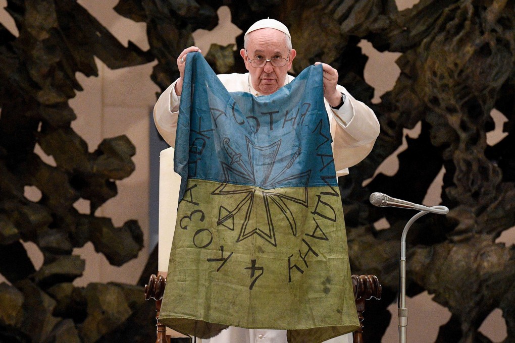 Pope Francis holding a flag of Ukraine in April. File photo: AFP