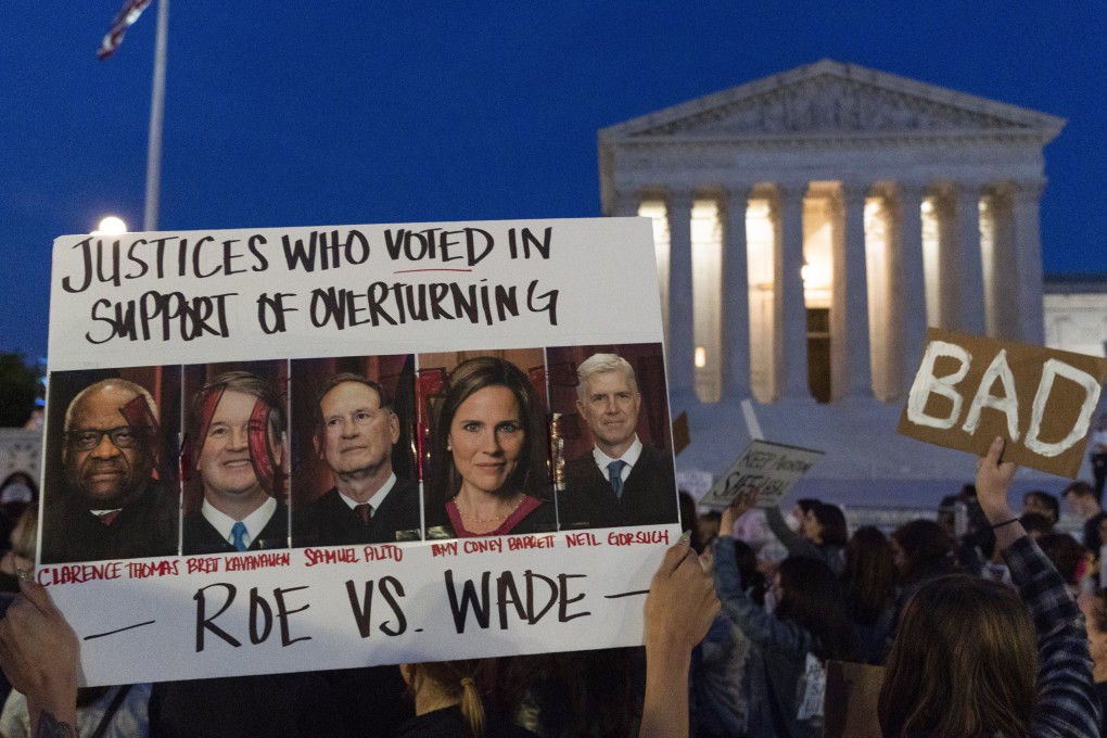 A protester holds a sign with pictures of Supreme Court justices outside the US Supreme Court in Washington. Photo: AP