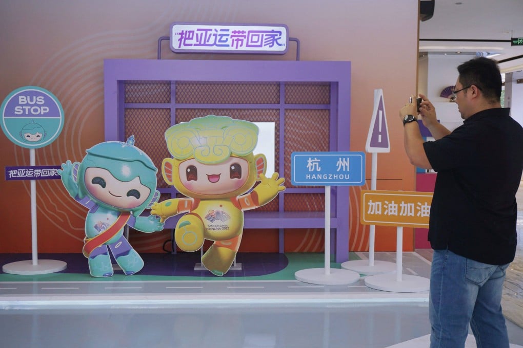 A man takes photos of mascots of the 2022 Asian Games in Hangzhou, in China’s eastern Zhejiang province on May 6, 2022. Photo: AFP