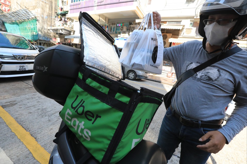 A food delivery rider wears both a helmet and a mask in Sham Shui Po in November 2021. Photo: Felix Wong