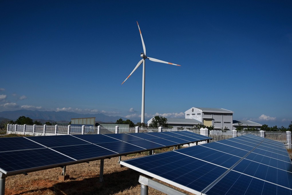 A wind turbine is seen surrounded by solar panels at a wind farm in southern Vietnam’s Binh Thuan province. Photo: AFP
