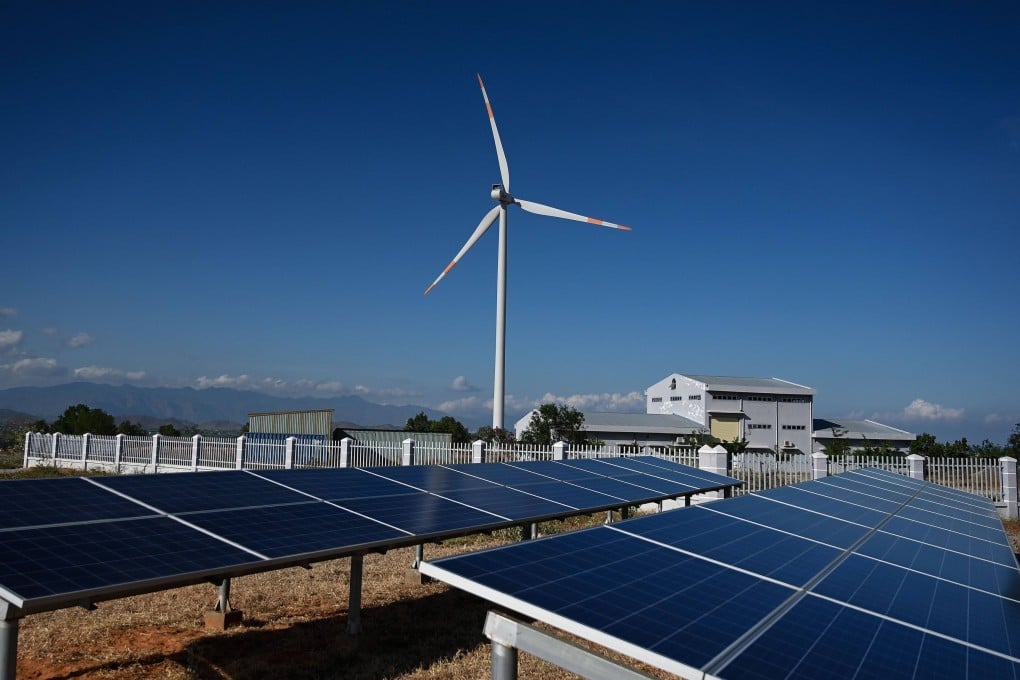 A wind turbine is seen surrounded by solar panels at a wind farm in southern Vietnam’s Binh Thuan province. Photo: AFP