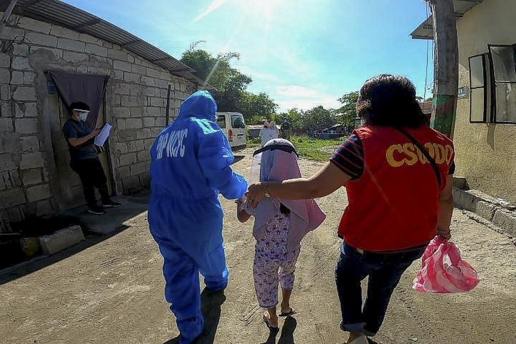 A child suspected to have been abused online is rescued in an operation in Angeles City, the Philippines, in February 2021. Nine children were rescued and one woman arrested. Photo: Red Door News/Australian Federal Police