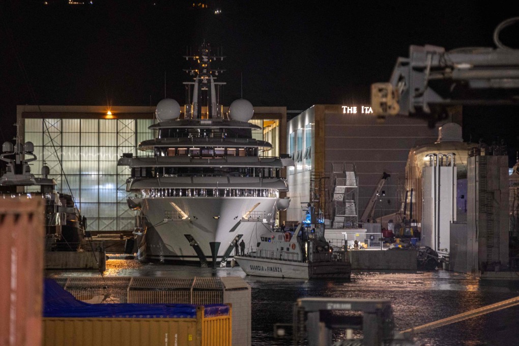 An Italian police boat is seen in front of the Scheherazade superyacht, docked at the port of Marina di Carrara on Friday. Photo: AFP