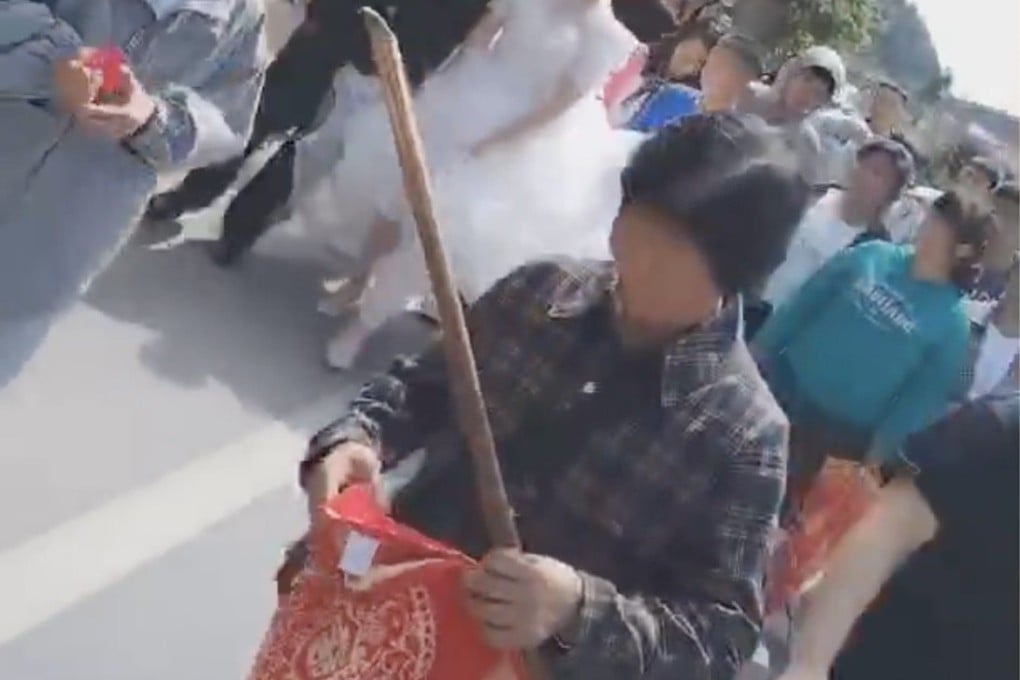 A Chinese grandma wields a stick to prevent wedding pranks. Photo: Douyin