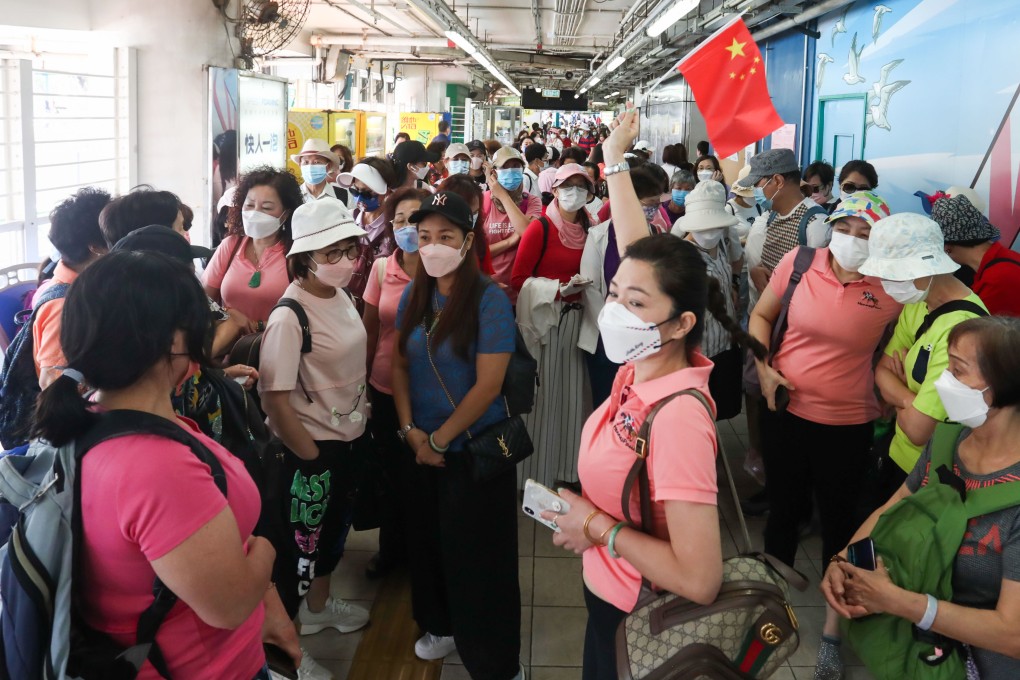 Crowds at the ferry pier headed for Cheung Chau, as thousands flocked there to enjoy the first long weekend since authorities further eased Covid-19 measures. Photo: Jonathan Wong