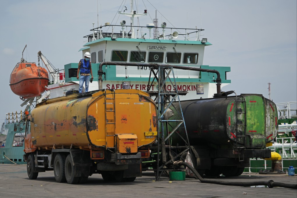 Palm oil is loaded into trucks from a tanker docked in Jakarta, Indonesia. Photo: Bloomberg