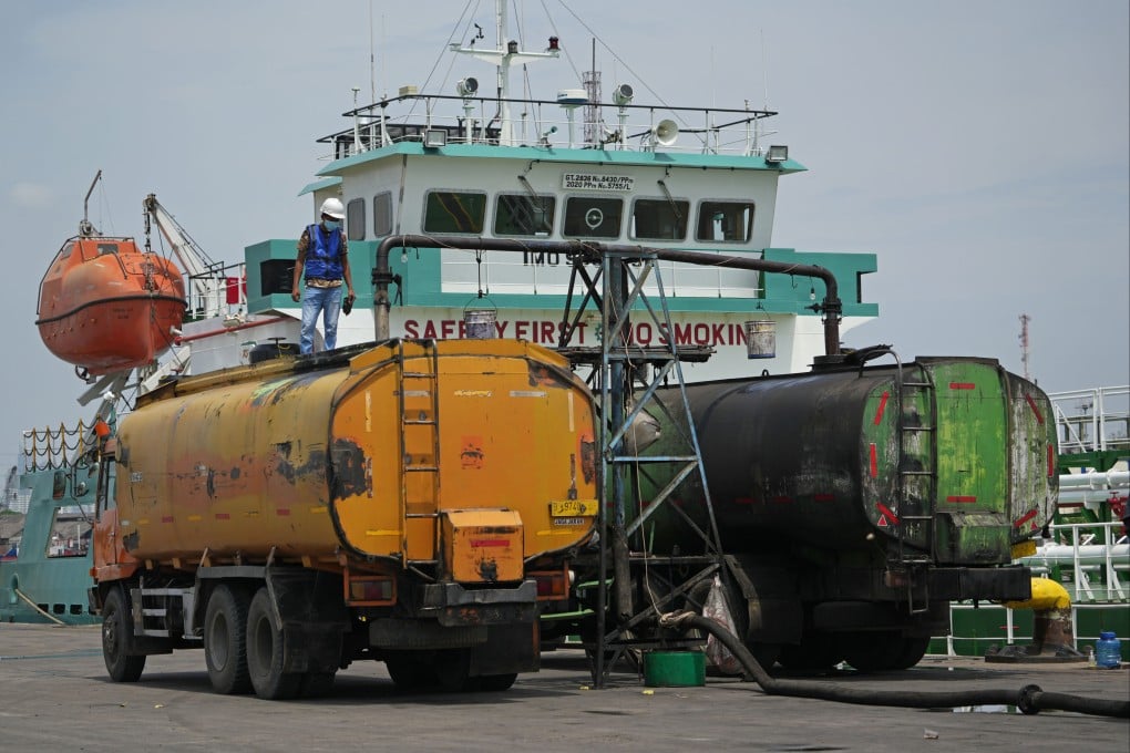 Palm oil is loaded into trucks from a tanker docked in Jakarta, Indonesia. Photo: Bloomberg