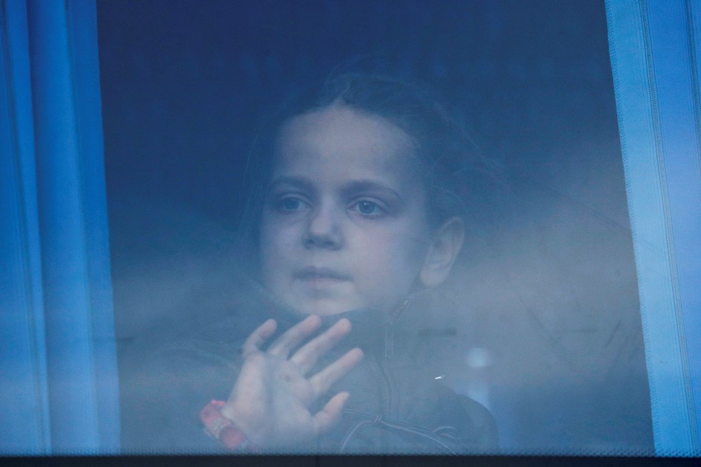 A girl looks through the bus window as civilians evacuated from Azovstal steel plant in Mariupol arrive at a temporary accommodation centre in the village of Bezimenne, Ukraine on May 6. Photo: Reuters
