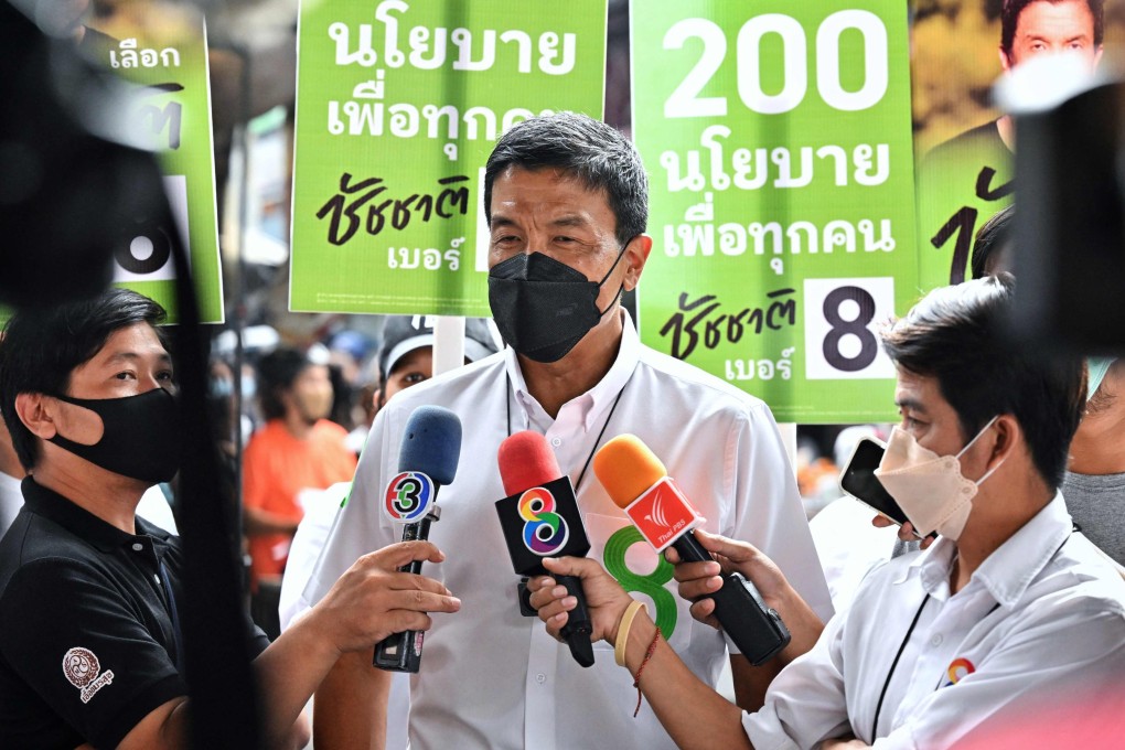 Former transport minister Chadchart Sittipunt speaks to reporters as he campaigns in Phayathai district. Photo: AFP