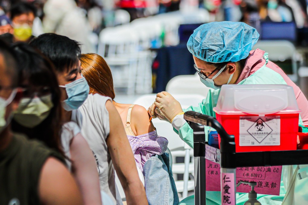 People get their Covid-19 booster jab inside the Taipei Metro station. Photo: EPA/EFE