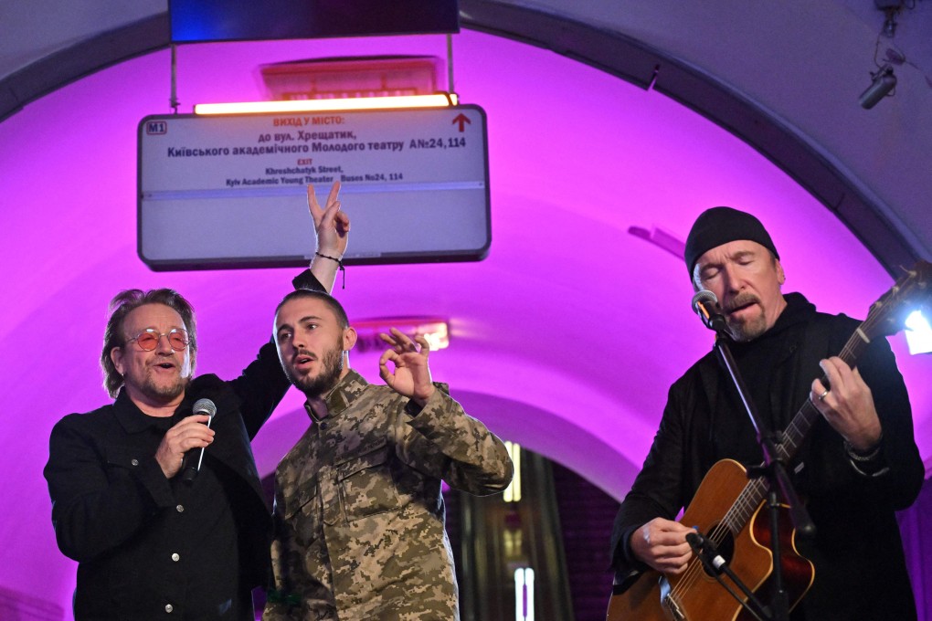 U2’s Bono, left, Ukrainian musician and soldier Antytila, centre, and U2 guitarist David Howell Evans, also known as The Edge, perform at an underground station in Kyiv, Ukraine on Sunday. Photo: AFP / Getty Images / TNS