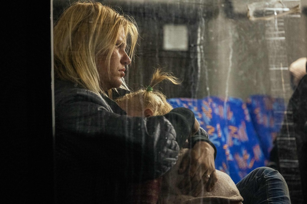 A woman hugs her child as people evacuated from Mariupol arrive on buses in Zaporizhzhia, southern Ukraine on May 8. Photo: AFP