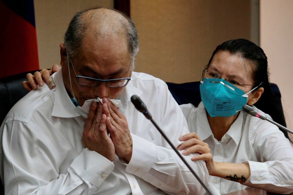 Lee Ming-che, left, a Taiwanese activist who was jailed in China for five years, takes part in a press conference with his wife Li Ching-yu at the parliament in Taipei on May 10, 2022. Lee returned home in April. Photo: AFP