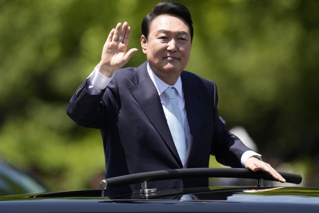 South Korean President Yoon Suk-yeol waves from a car after the presidential inauguration outside the National Assembly in Seoul on May 10. Photo: AP