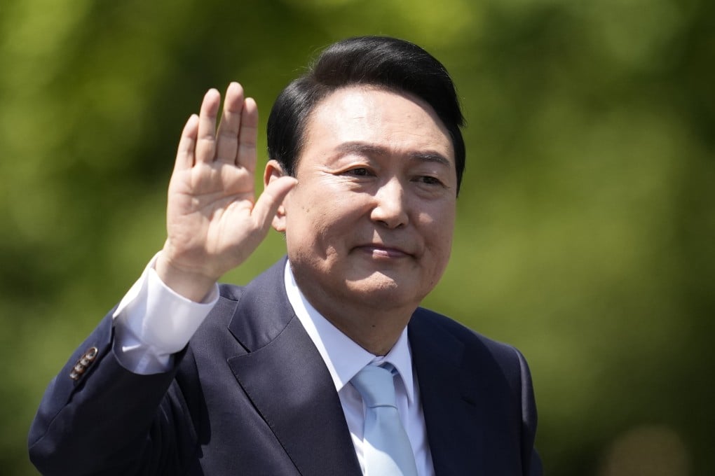 South Korea’s new President Yoon Suk Yeol waves from a car after the Presidential Inauguration outside the National Assembly in Seoul, South Korea, on Tuesday. Photo: AP Photo
